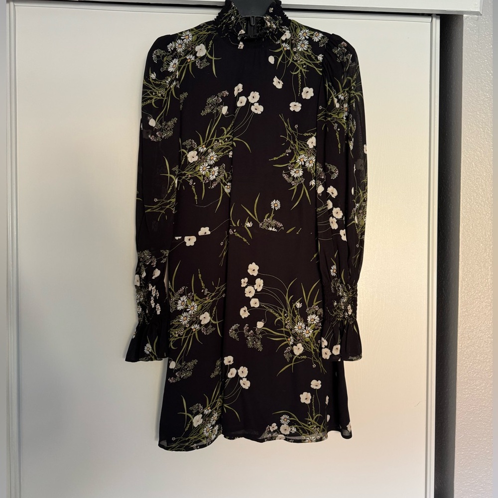Reformation black dress with smart detail around the rest and neck line.